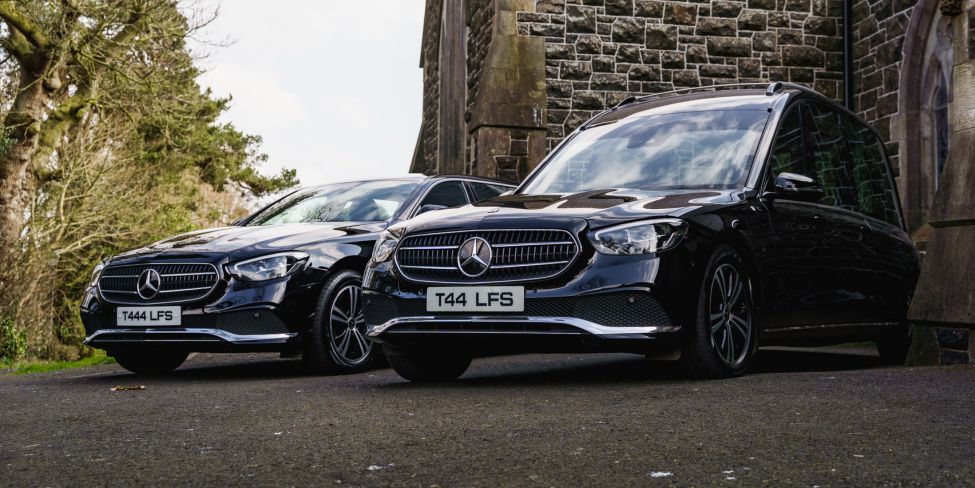 Logans funeral service cars in front of church