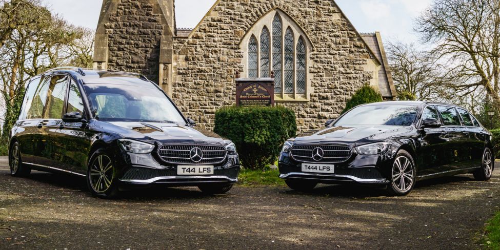Logans funeral service cars in front of church